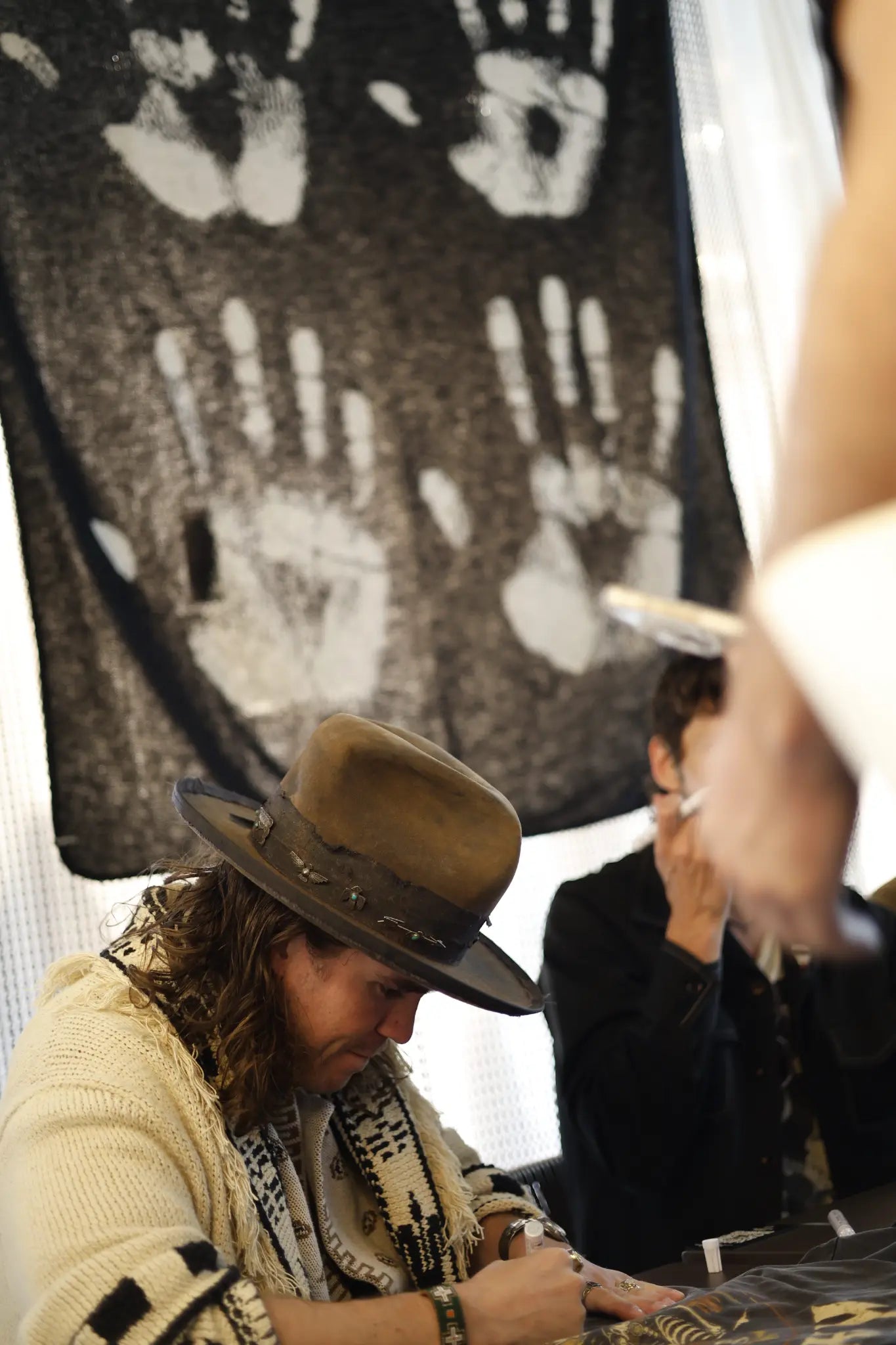Kaleo signing albums with the Varma handprints blanket — sold out at the concert